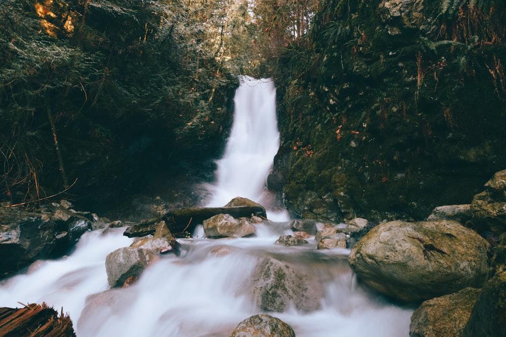 time-lapse photography of waterfalls and stones during daytime
