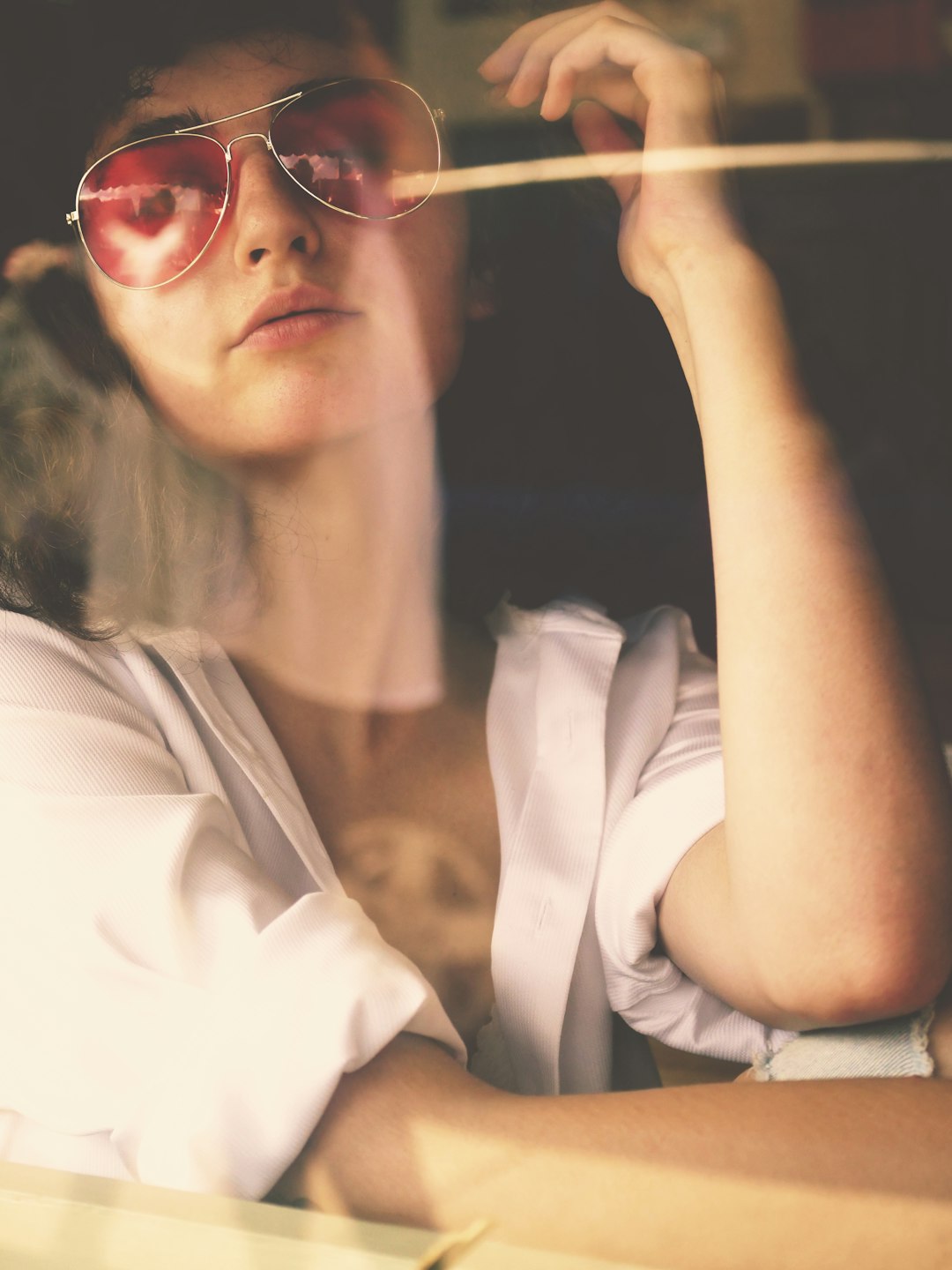 woman wearing red aviator sunglasses