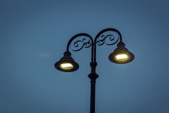 black 2-light street lamp turned on during night