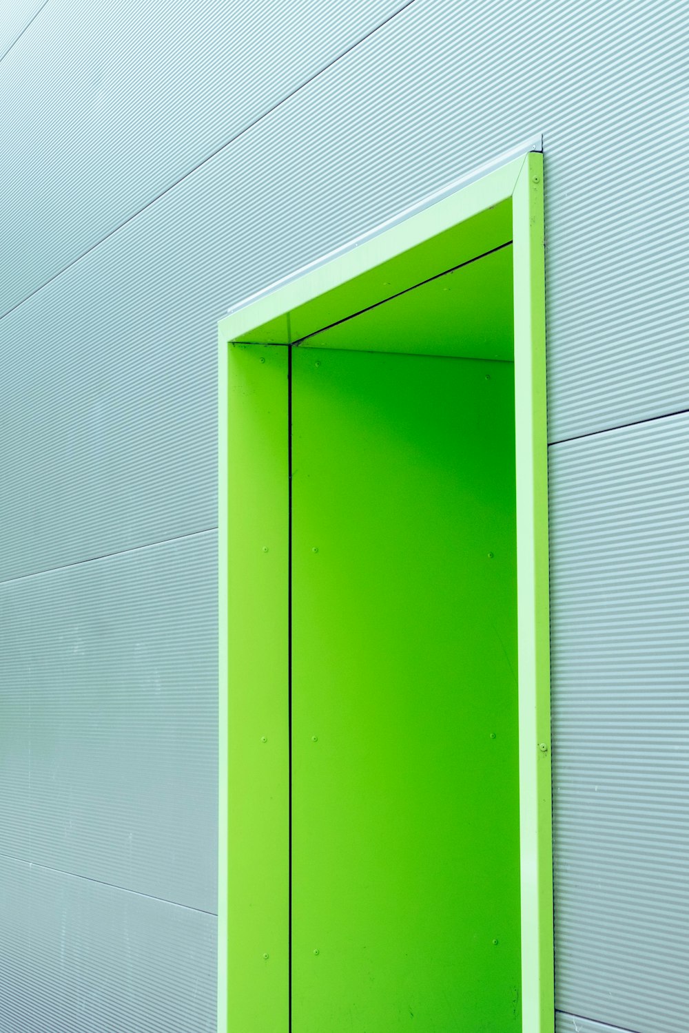 Puerta verde con pared gris