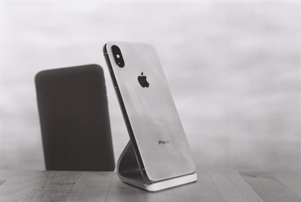 silver iPhone X on stand