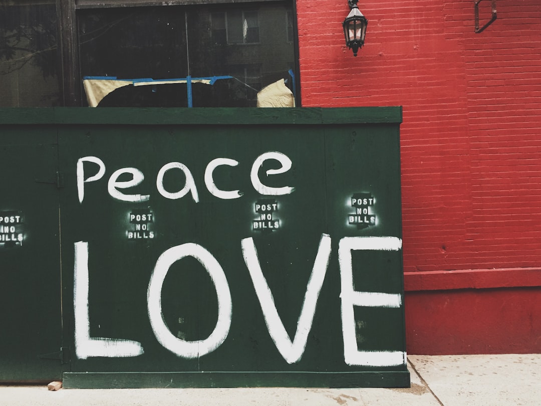 Peace Love painted on green wall, Love