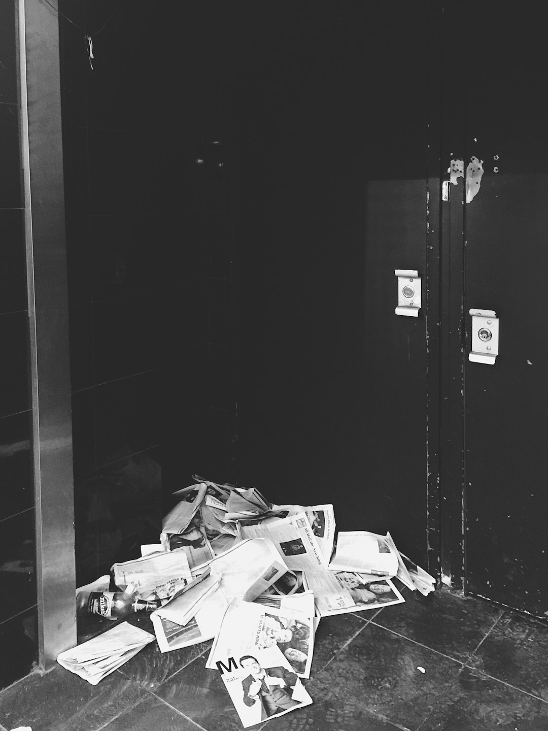 grayscale photo of papers on floor