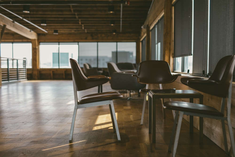 a room with a lot of chairs and windows