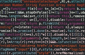 A close-up view of computer programming code written in a variety of colors, including white, blue, orange, and green. The text appears to be JavaScript, featuring syntax elements like functions, variables, and keywords.