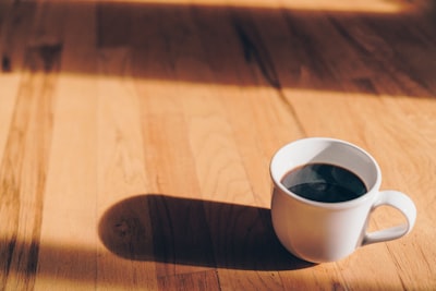 white ceramic mug on brown wooden surface boho google meet background