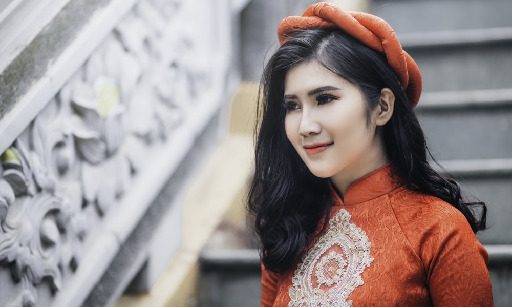 woman wearing red cheongsam top near stair