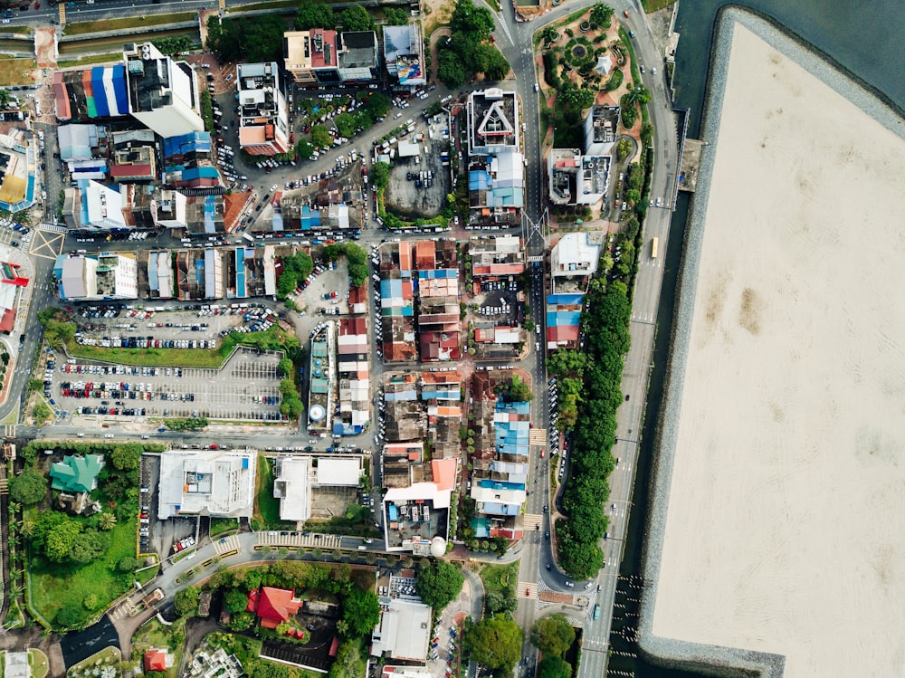 aerial view of houses near body of water at daytime