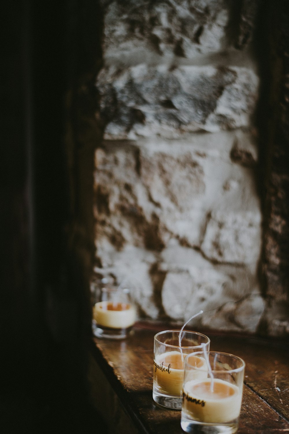 three votive candles on table edge