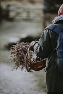 Sophie smiling warmly while holding a basket full of freshly picked wild plants