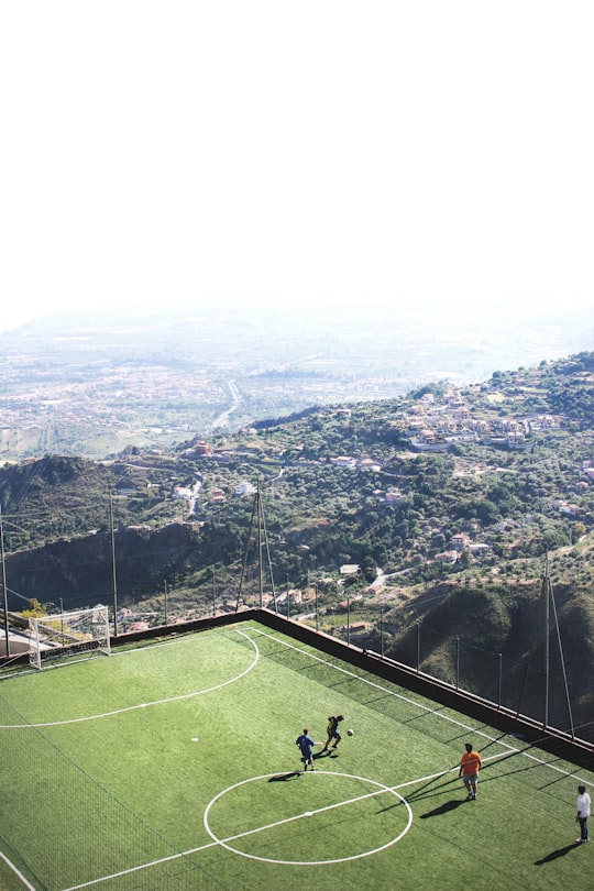 men playing soccer during daytime in Castelmola Italy