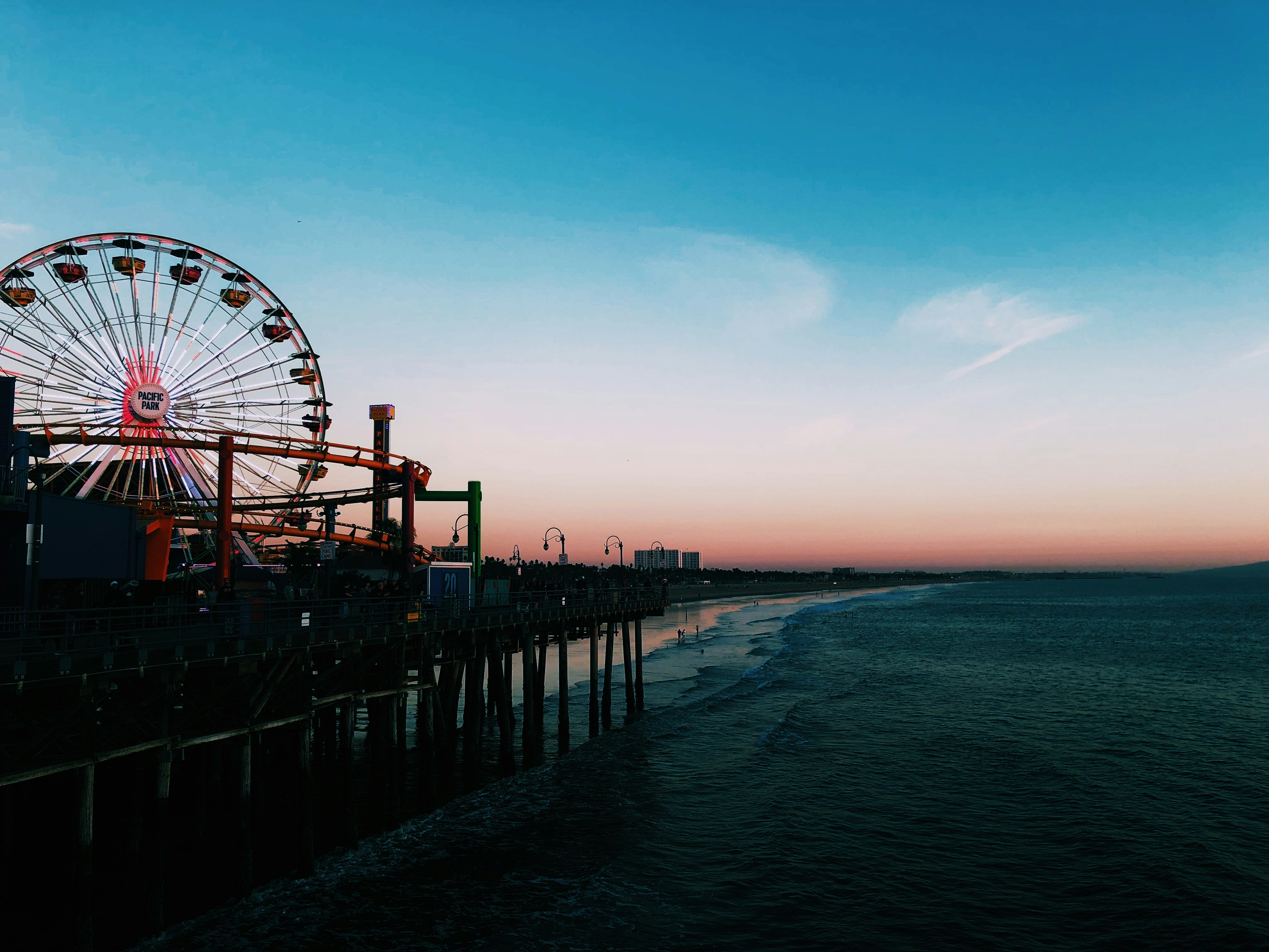 ferris wheel near beach shore leisure activity teams background