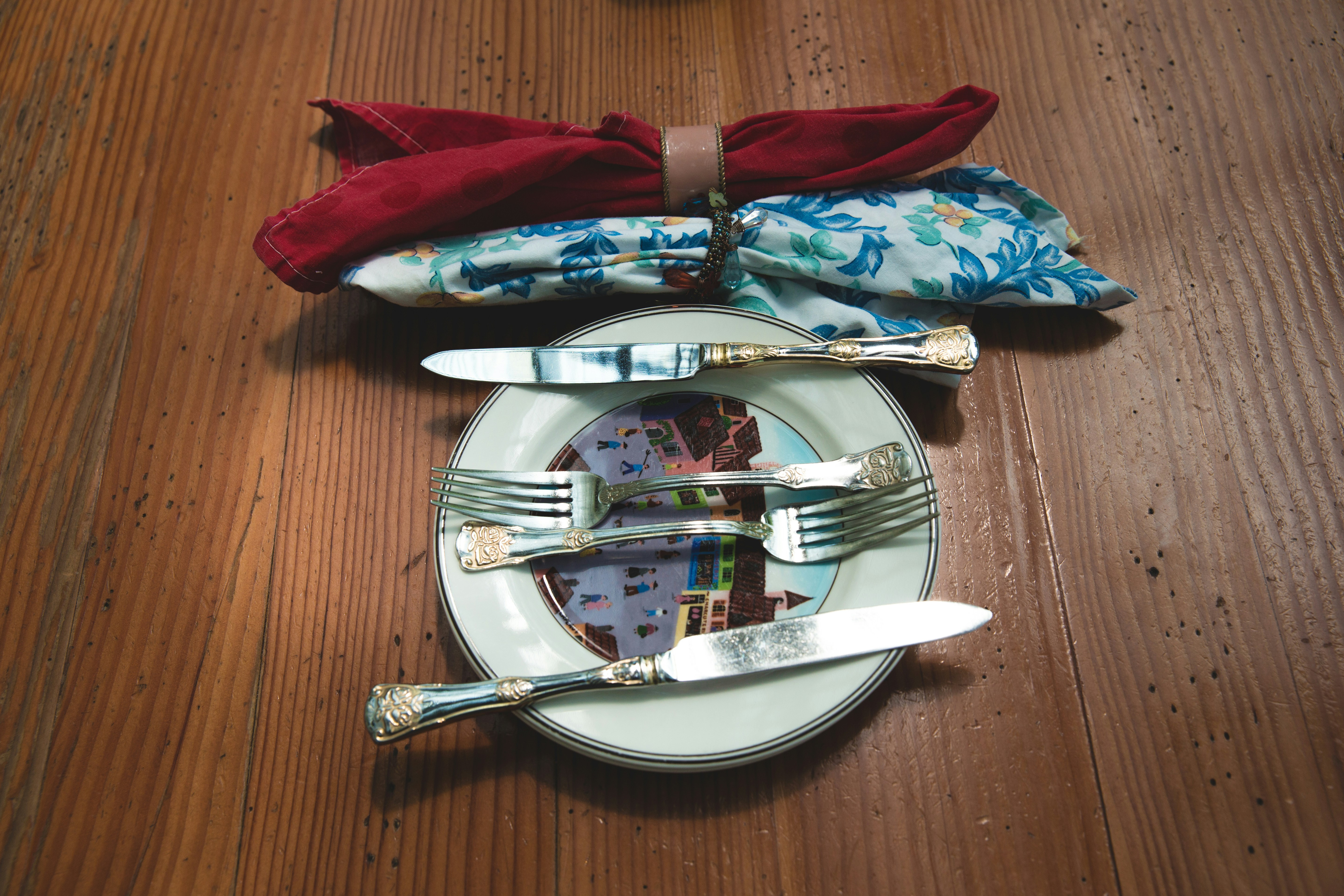 silver flatware set on white plate on tabletop, Dinner Plans?