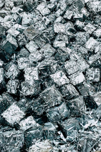 a pile of silver foil sitting on top of a pile of silver foil