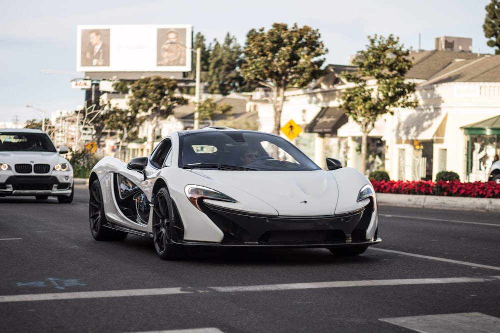 white coupe on road