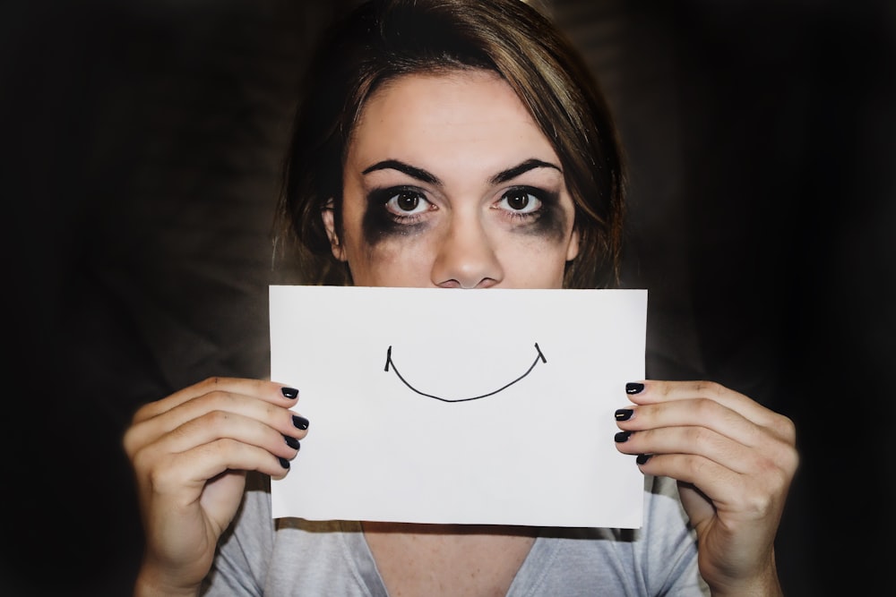 person holding white printer paper