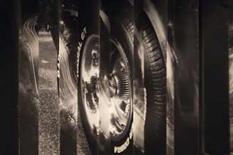 Close-up of a sleek racing car's wheel in motion, capturing the dynamic energy of motorsport.