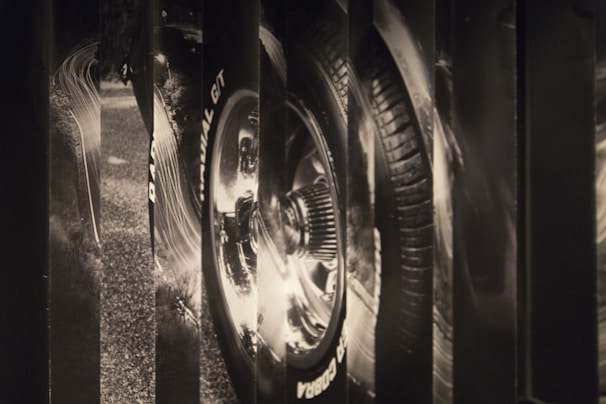 A sleek close-up of a racing car's wheel in motion, capturing speed and detail.