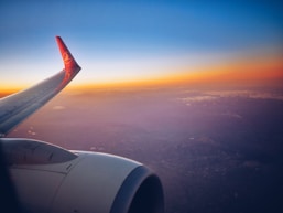 photograph white and red airplane wing