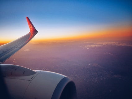 photograph white and red airplane wing