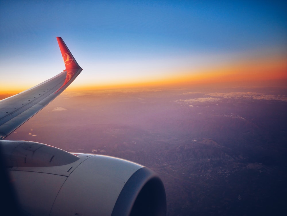 photograph white and red airplane wing