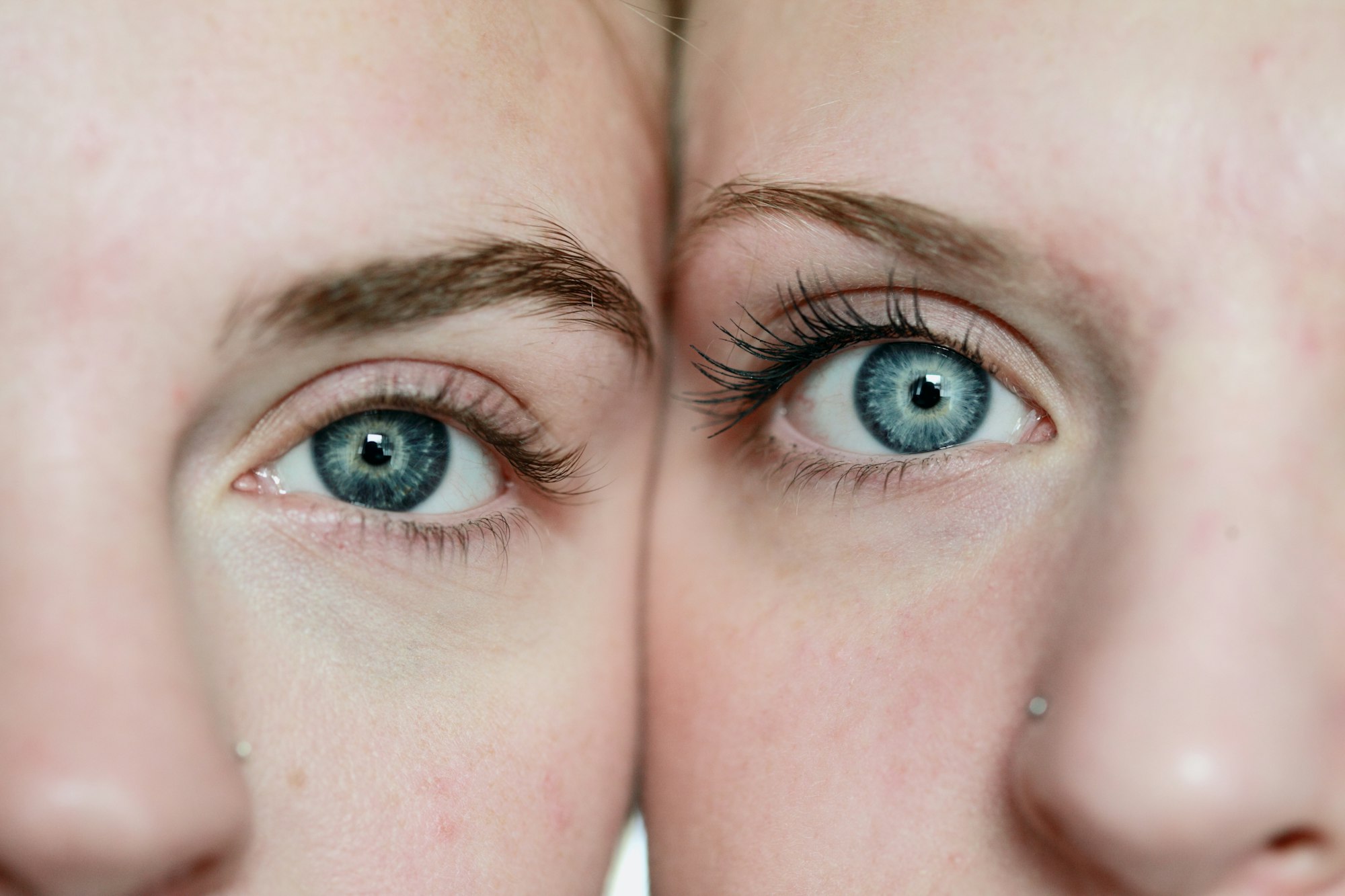 A close up macro shot of two girls with blue eyes. These girls are my two eldest daughters. I shot this using available natural light from a south facing window.