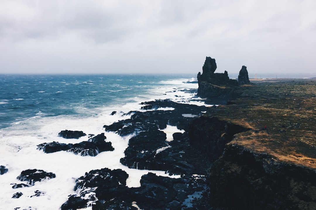 Black near. Iceland Sea. Rangarnir Sea Stacks. Stack Rock Fort. Rock formations Black.