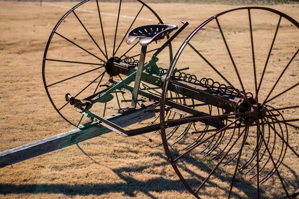 black and gray farm equipment on brown open field