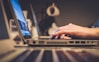 person using silver laptop computer on desk