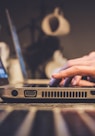 person using silver laptop computer on desk