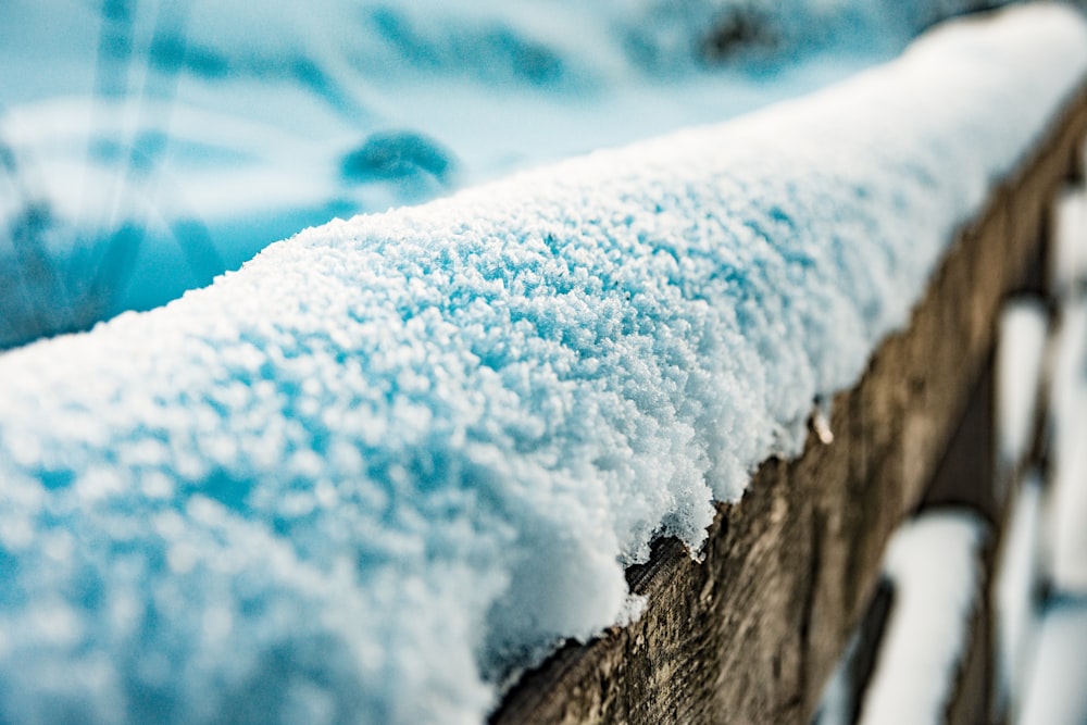 brown wooden fence covered by snow