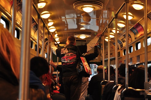 A busy bus interior filled with passengers.
