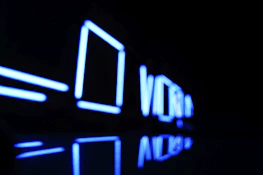 Abstract neon gradient shapes flowing over a deep midnight blue background, symbolizing digital acceleration.