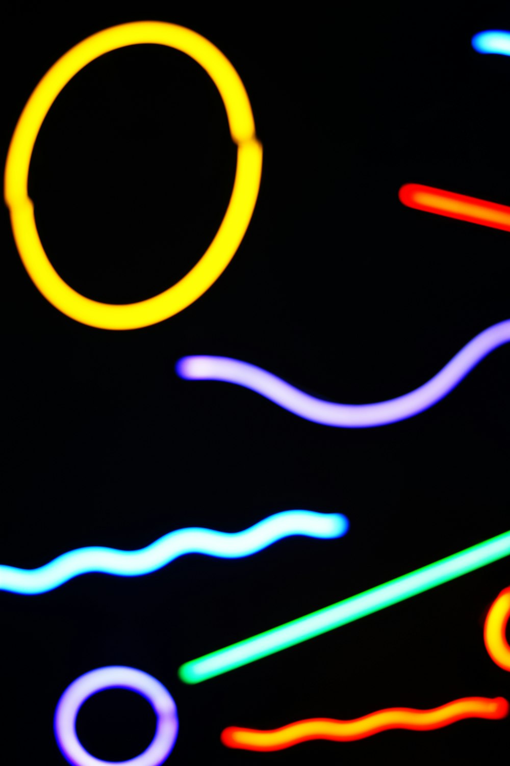 a close up of a neon sign on a black background
