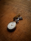 round gold-colored pocketwatch at 2:55