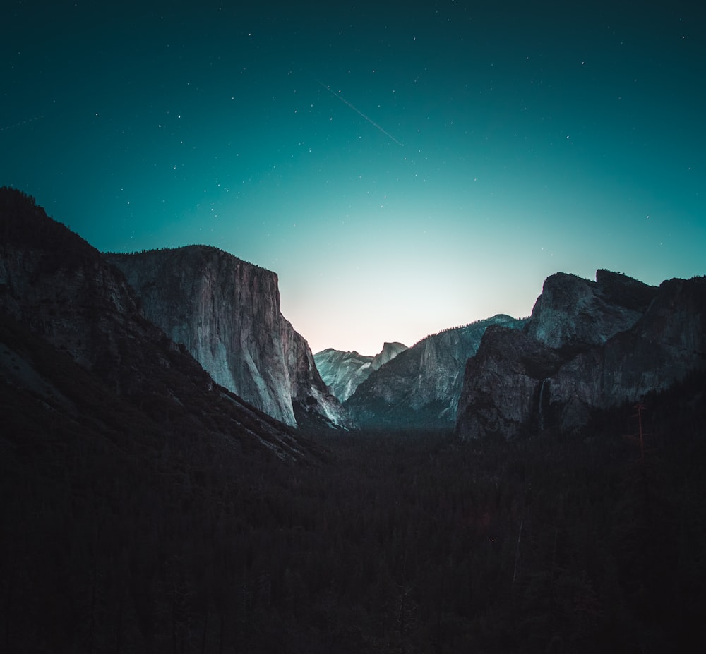 gray and black mountain under starry sky