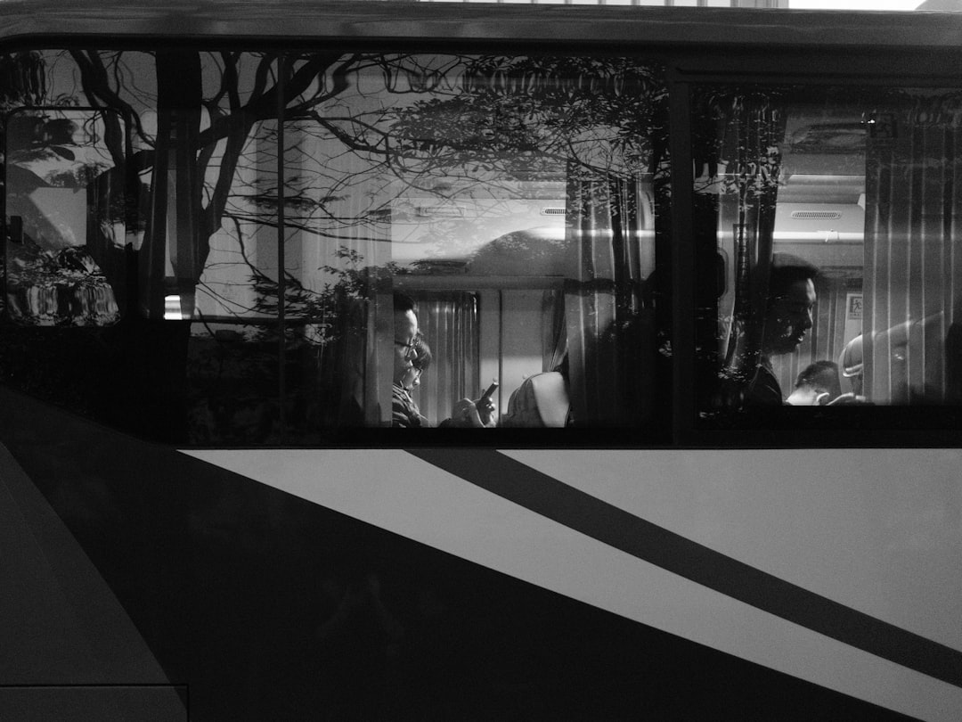 black and white photo of people riding bus