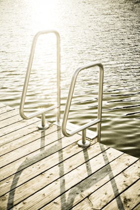 Close-up of fiberglass reinforced polymer grates installed on a Canadian marina dock under bright sunlight.