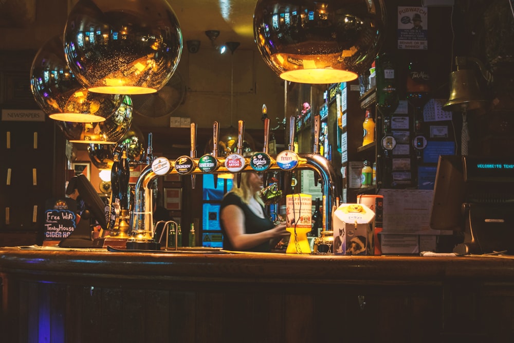 woman standing inside bar
