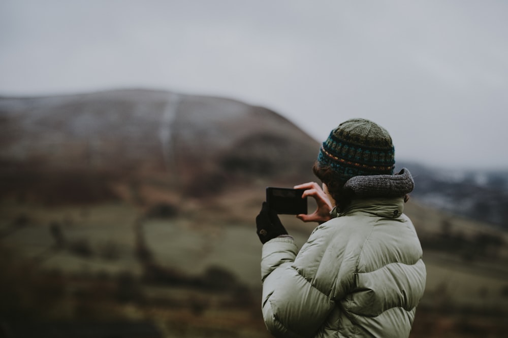 person using smartphone taking photo