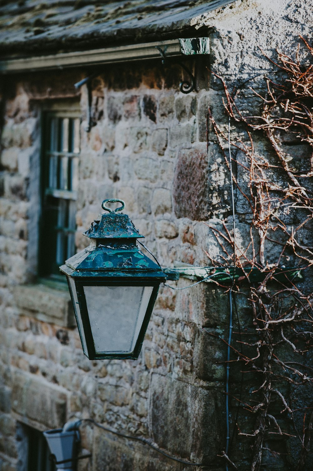 black and white sconce lamp outside house