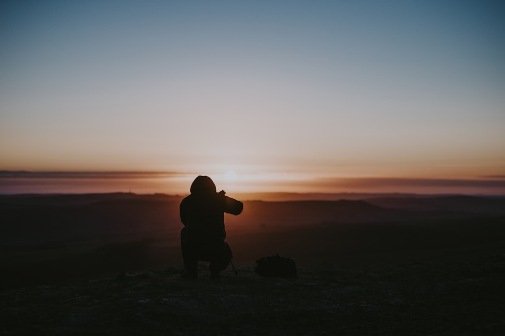 silhouette of person taking photo