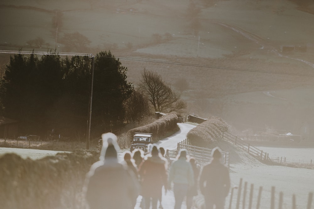 people walking on pathway near vehicle