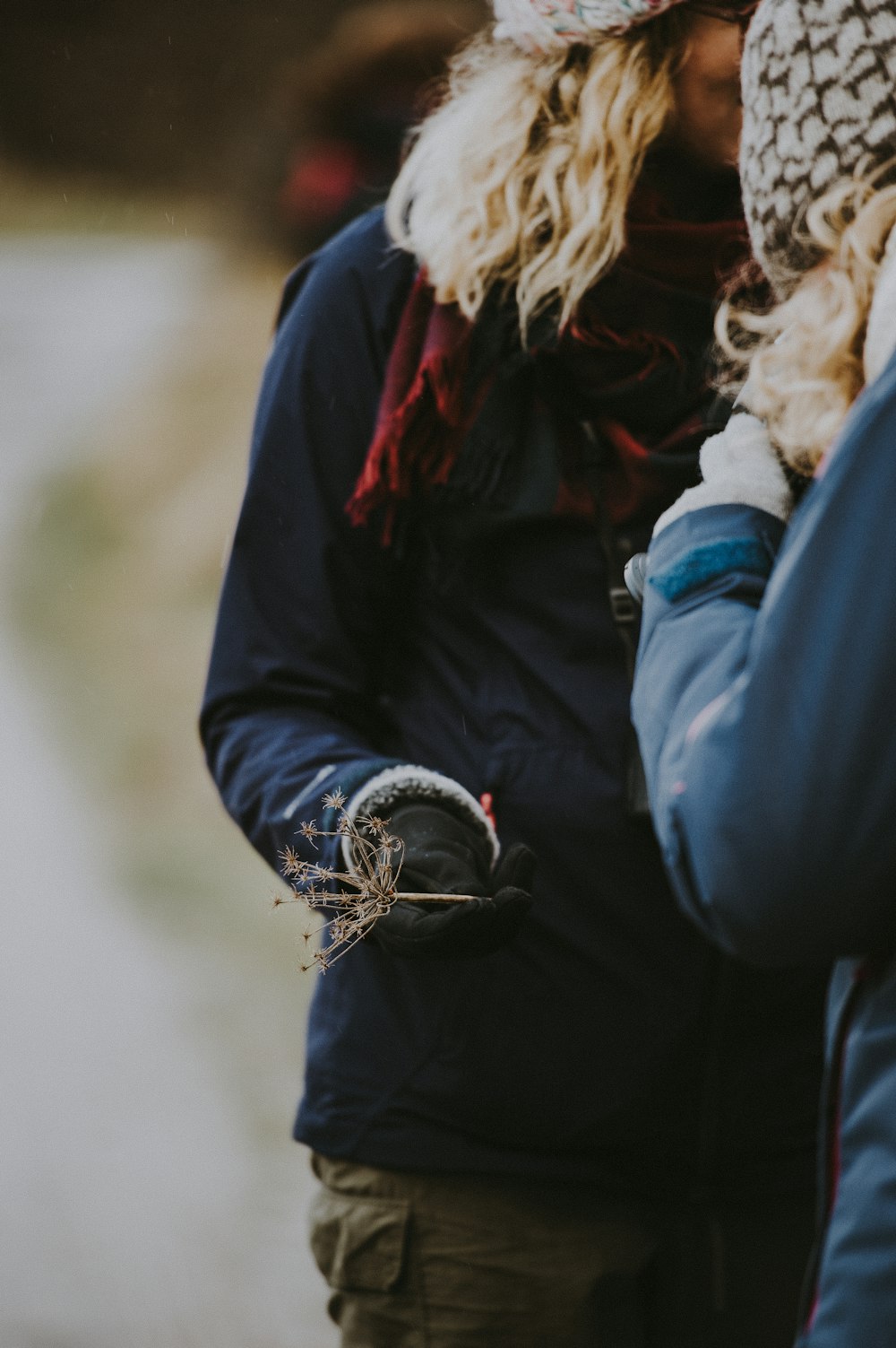 selective focus photography of woman standing in front of woman