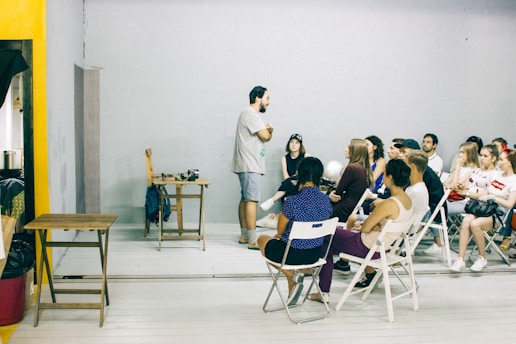 A minimalist boardroom setup with a small group of professionals in conversation.