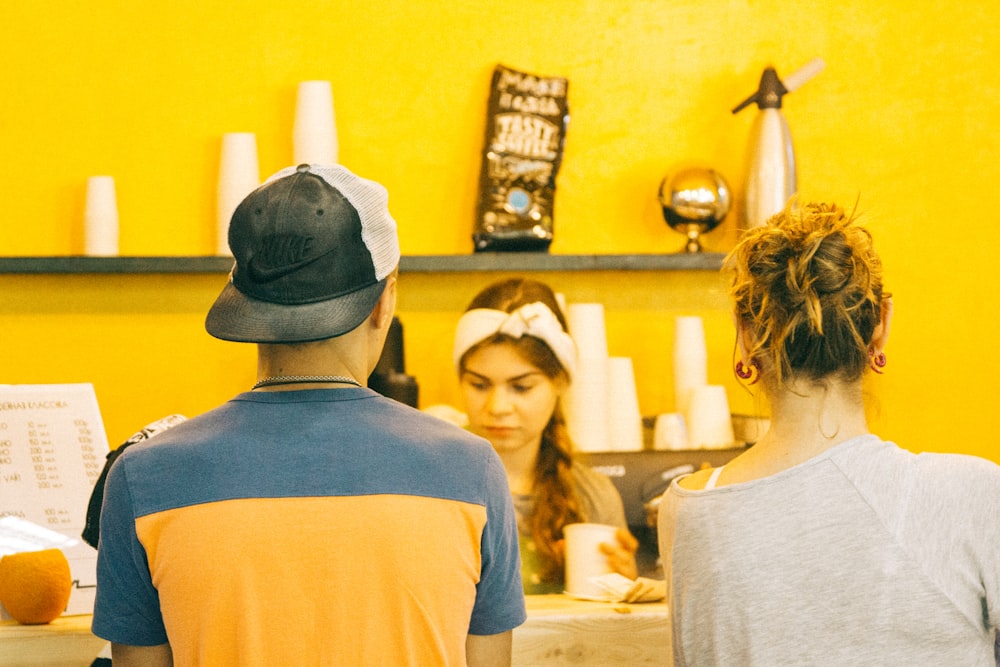 man standing near woman on table