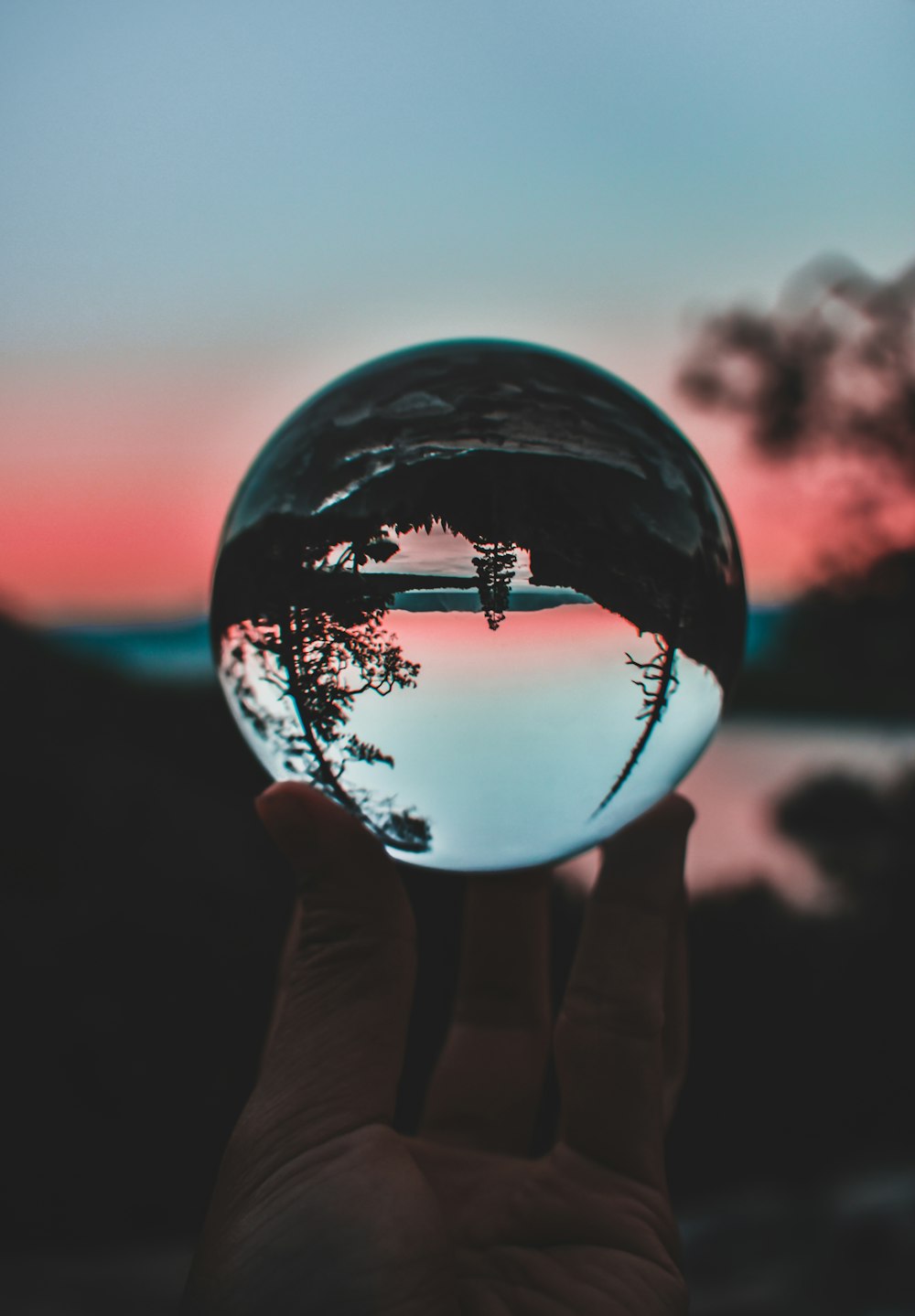 person holding clear crystal ball