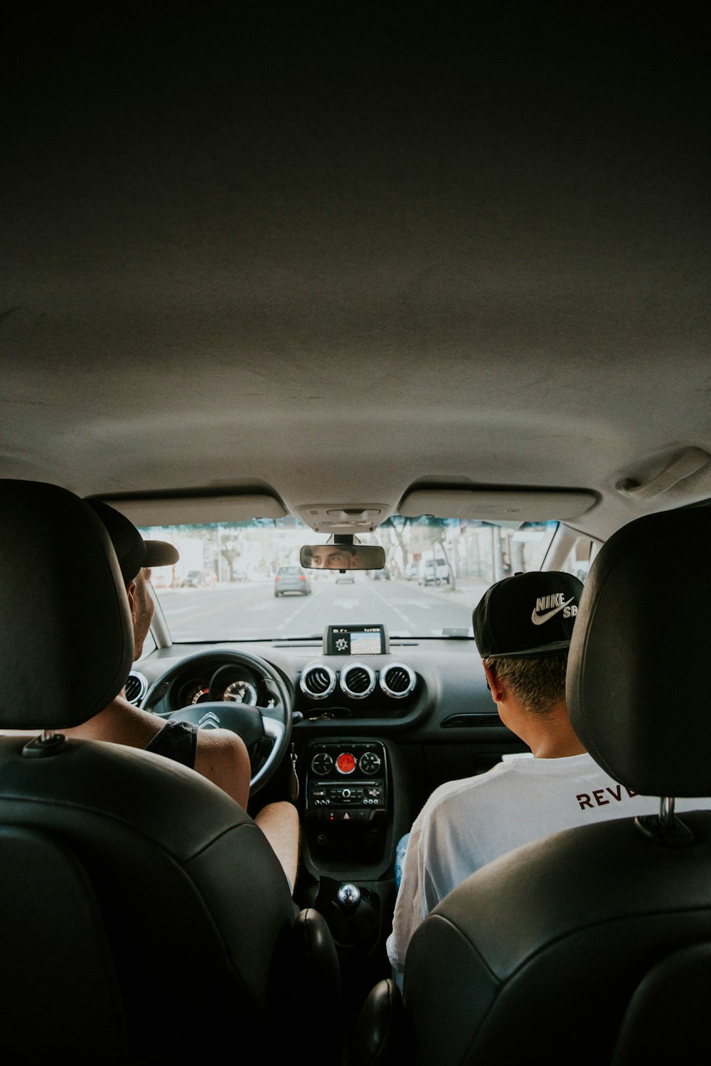 two person seating on car