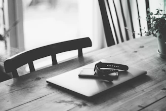 A serene workspace with soft natural light highlighting minimalist home goods arranged neatly on a wooden table.