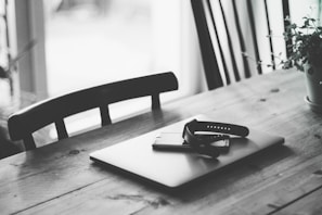 Minimalist workspace featuring a laptop and an orlienne smart watch strap placed beside a notebook